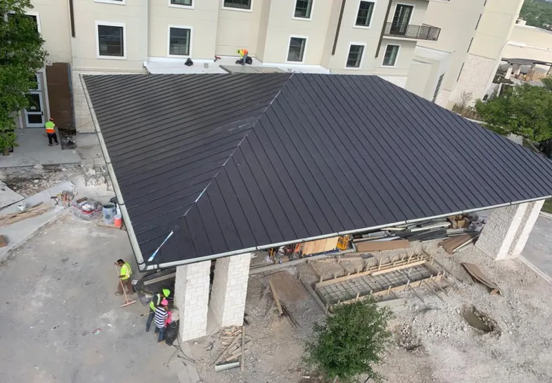 Metal roofing installation team working on a commercial building in Pacific